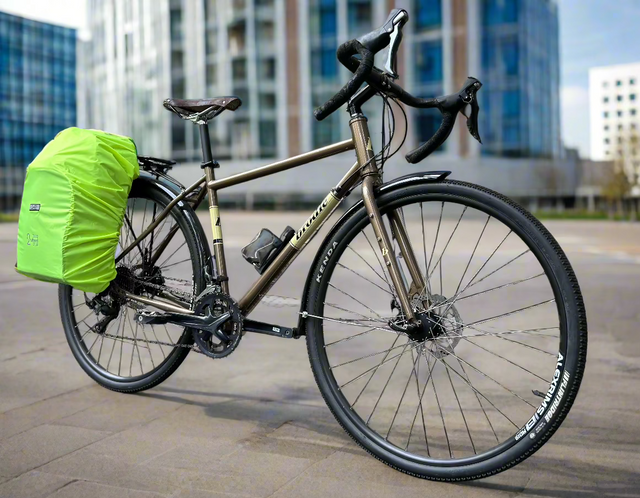 Two Wheel Gear Grey Inverter Pannier Backpack with rain cover attached to commuter bicycle